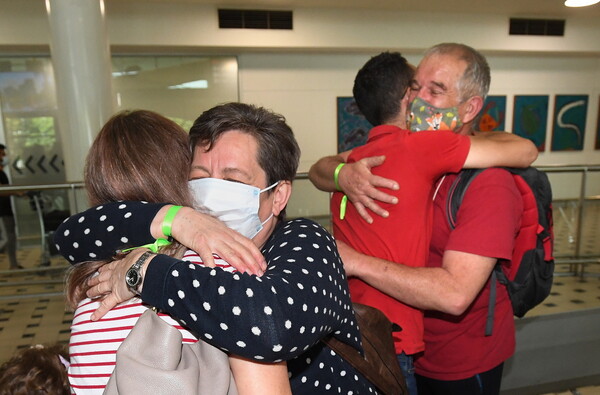 ‘Today we rejoined the world’: hugs, tears and Vegemite as Australia reopens international borders