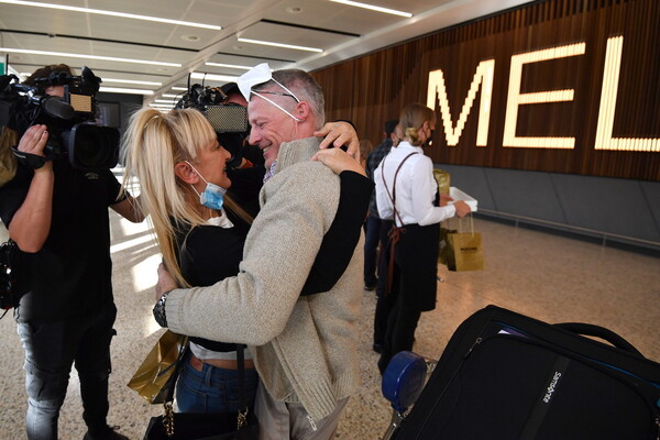 ‘Today we rejoined the world’: hugs, tears and Vegemite as Australia reopens international borders