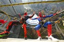 Acrobatic superheroes scale children's hospital to visit young patients