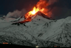 Italy’s Mount Etna spews lava down snow-covered slopes