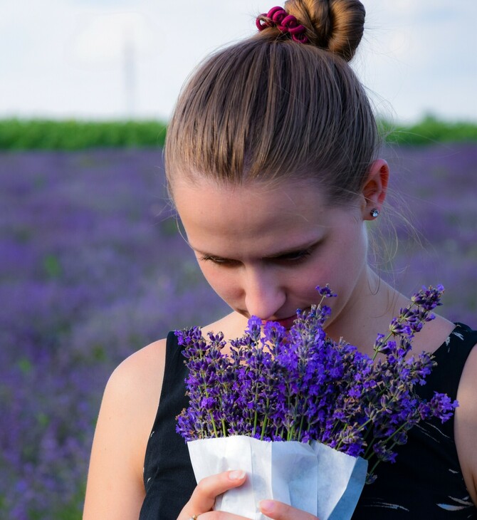 Γυναίκα μυρίζει λουλούδια