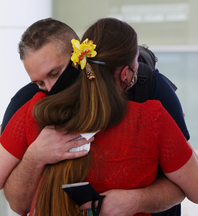 ‘Today we rejoined the world’: hugs, tears and Vegemite as Australia reopens international borders