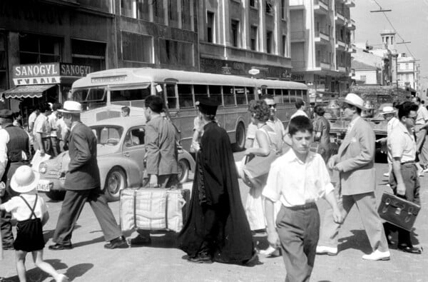 Greece, pedestrian and car traffic on street in Athens