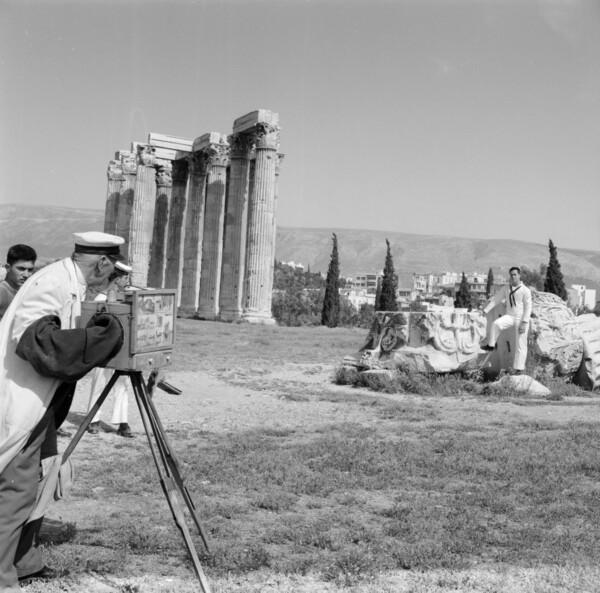 Greece, photographer taking picture of sailor at Temple of Olympian Zeus