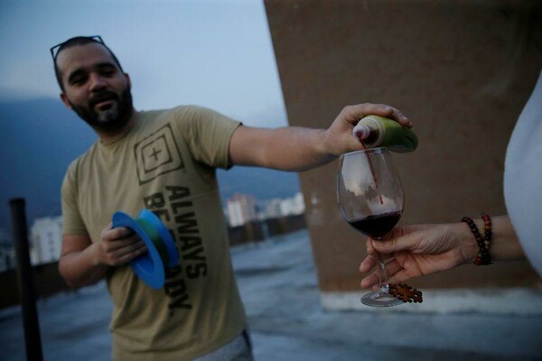 Οι Βενεζουελάνοι ξορκίζουν την καραντίνα με κρασί και συμπάθεια στις ταράτσες τους