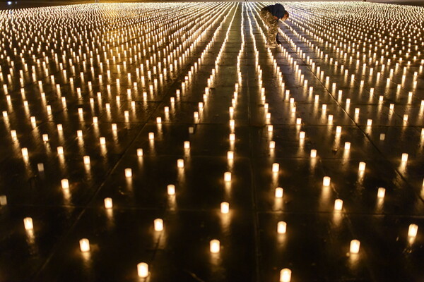 Swiss group lights 11,288 candles for COVID-19 victims