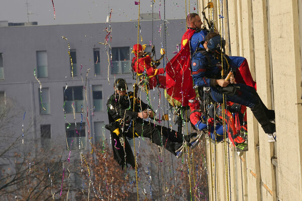 Acrobatic superheroes scale children's hospital to visit young patients