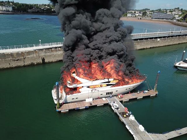 Superyacht sinks in Torquay harbour after large fire