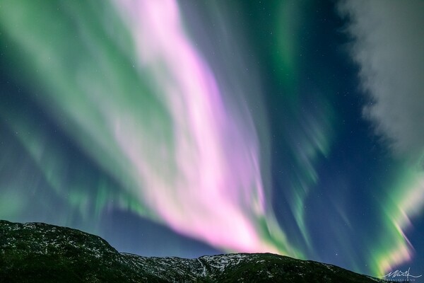 Solar Storm Causes Neon-Pink Northern Lights To Fill the Sky