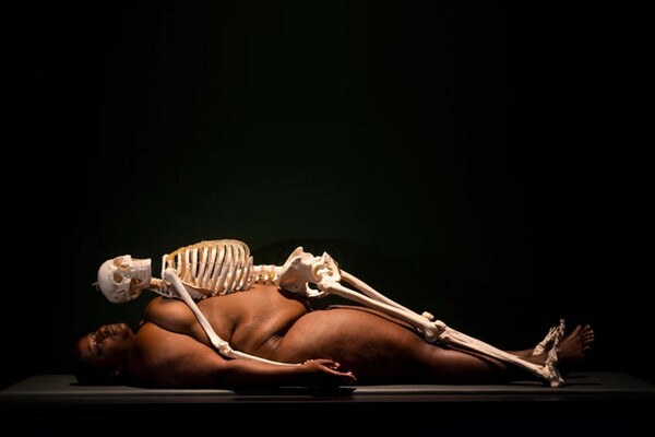 Visitors must squeeze between nude models to enter this art exhibition