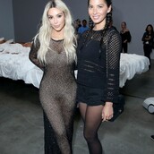 Η Kim Kardashian πάνω από τον γυμνό εαυτό της σε ένα κρεβάτι γεμάτο διάσημους