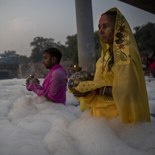 Ινδουιστές κάνουν μπάνιο και προσεύχονται στον ιερό ποταμό Yamuna καλυμμένοι με τοξικό αφρό