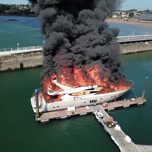 Superyacht sinks in Torquay harbour after large fire